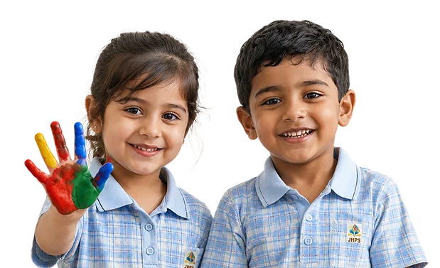 Two smiling JHPS students, one showing a hand painted with colours