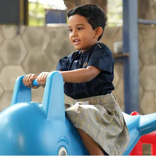 Young student playing on a ride-on toy
